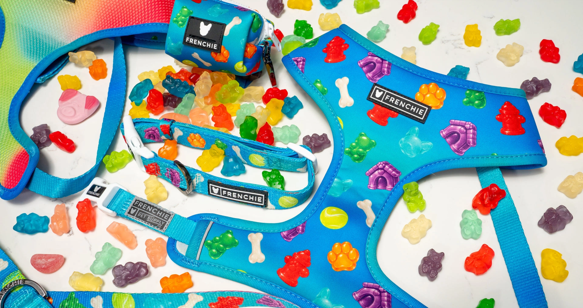 Gummies print harness and leash laid out with gummy candy